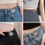 Metal pant waist tightener buttons clipped on jeans, ideal for belly chain ladies fashion and quick waistband adjustment."