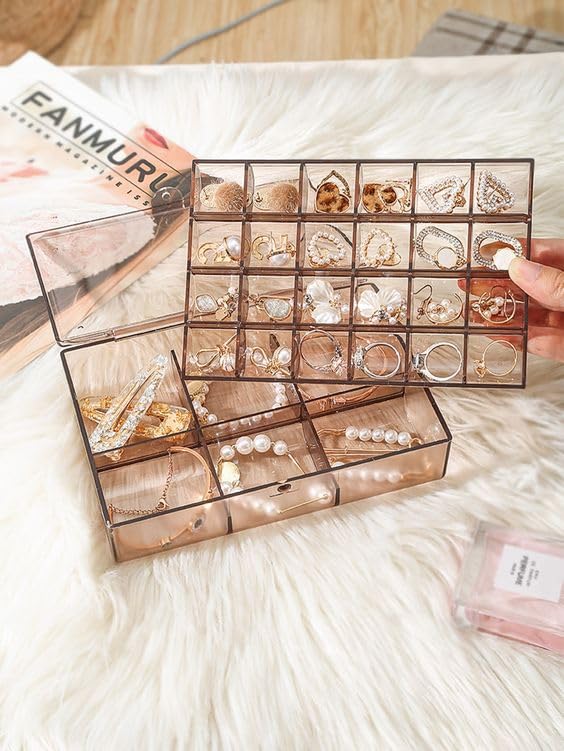 “A clear acrylic 2‐layer jewelry organizer box with velvet‐lined tray and necklace hooks, showing removable dividers and transparent lid”