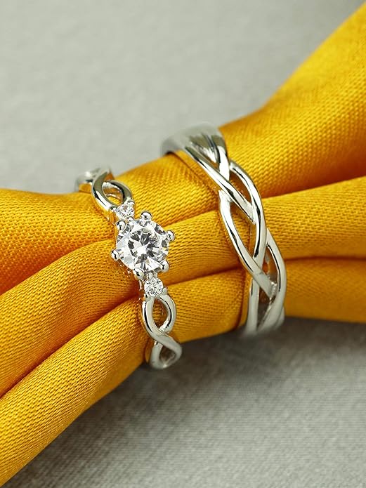 “A pair of elegant couples engagement rings with silver‑ toned plating, slim band widths, presented in a signature gift box”