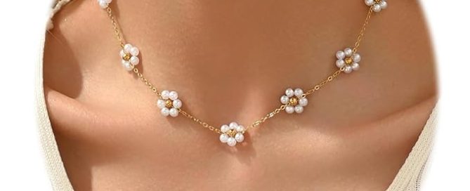Elegant pearl jewelry set with gold floral charm necklace with faux pearls displayed on white background